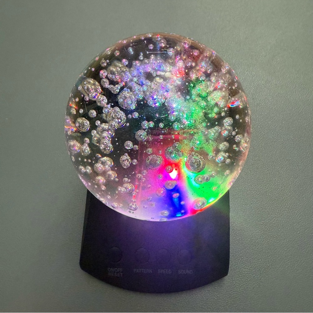 Colorful LED Light Sphere with Black Base and it makes relaxing sounds.